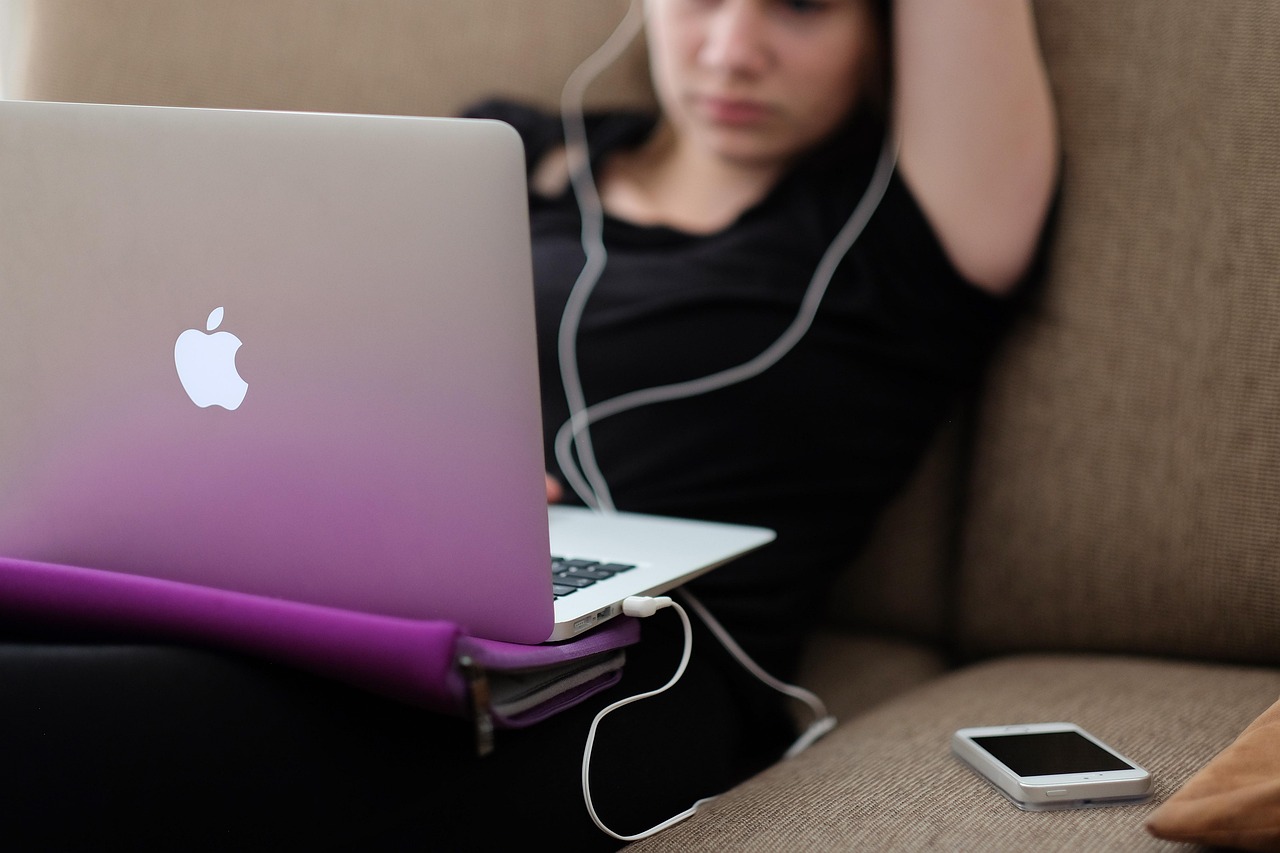 Person relaxing at home with a laptop and cup of tea
