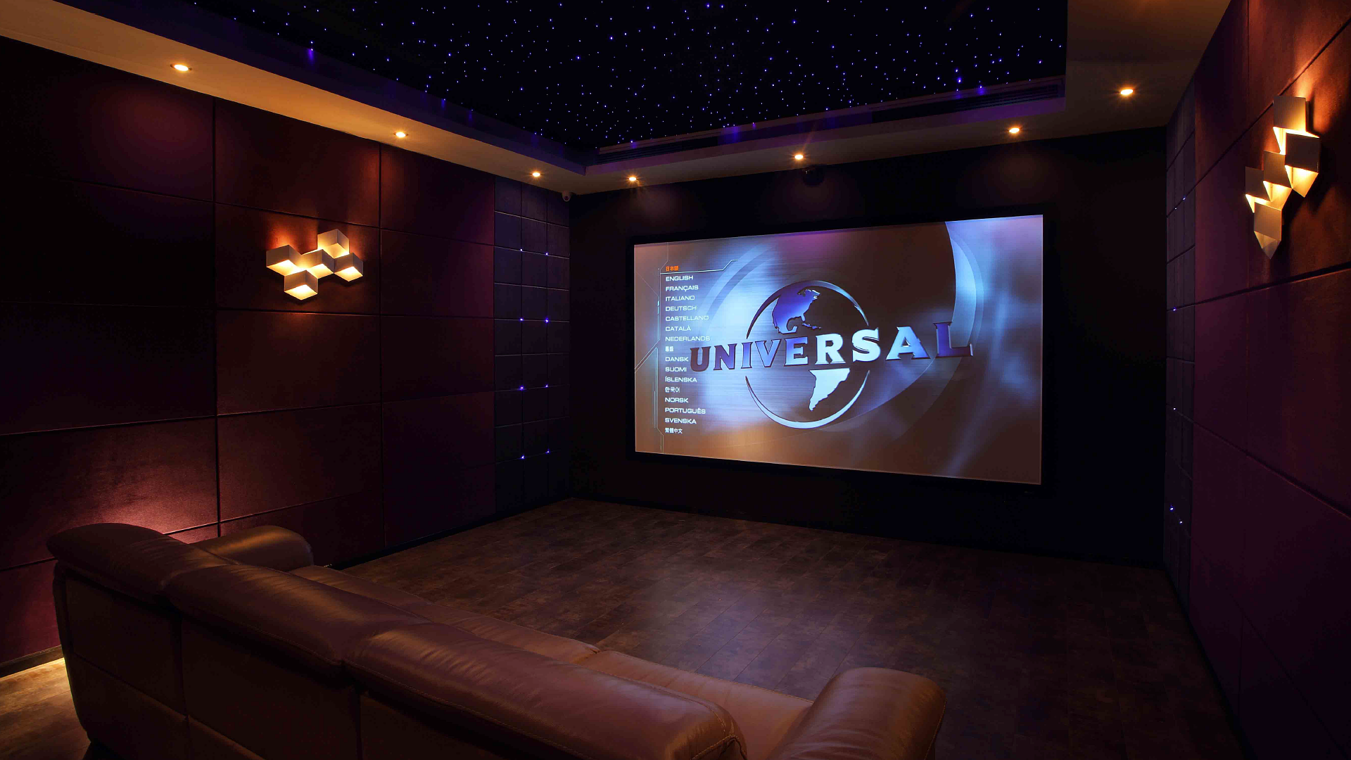 Dimly lit room with large screen displaying vivid nature imagery